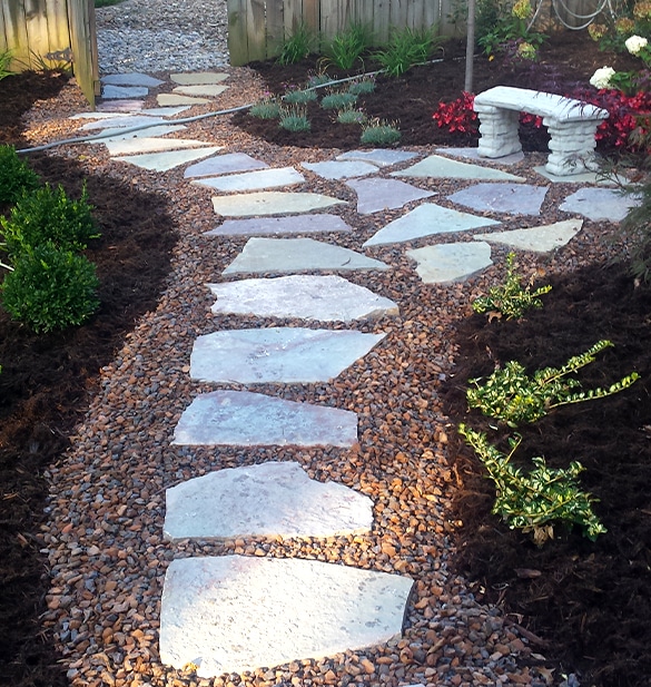 landscape design showing stepping stones set in gravel surrounded by greenery