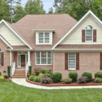 A well-maintained suburban house with impeccable landscaping and a freshly mown lawn, following the lawn requirements for the Louisville metro area beautifully.